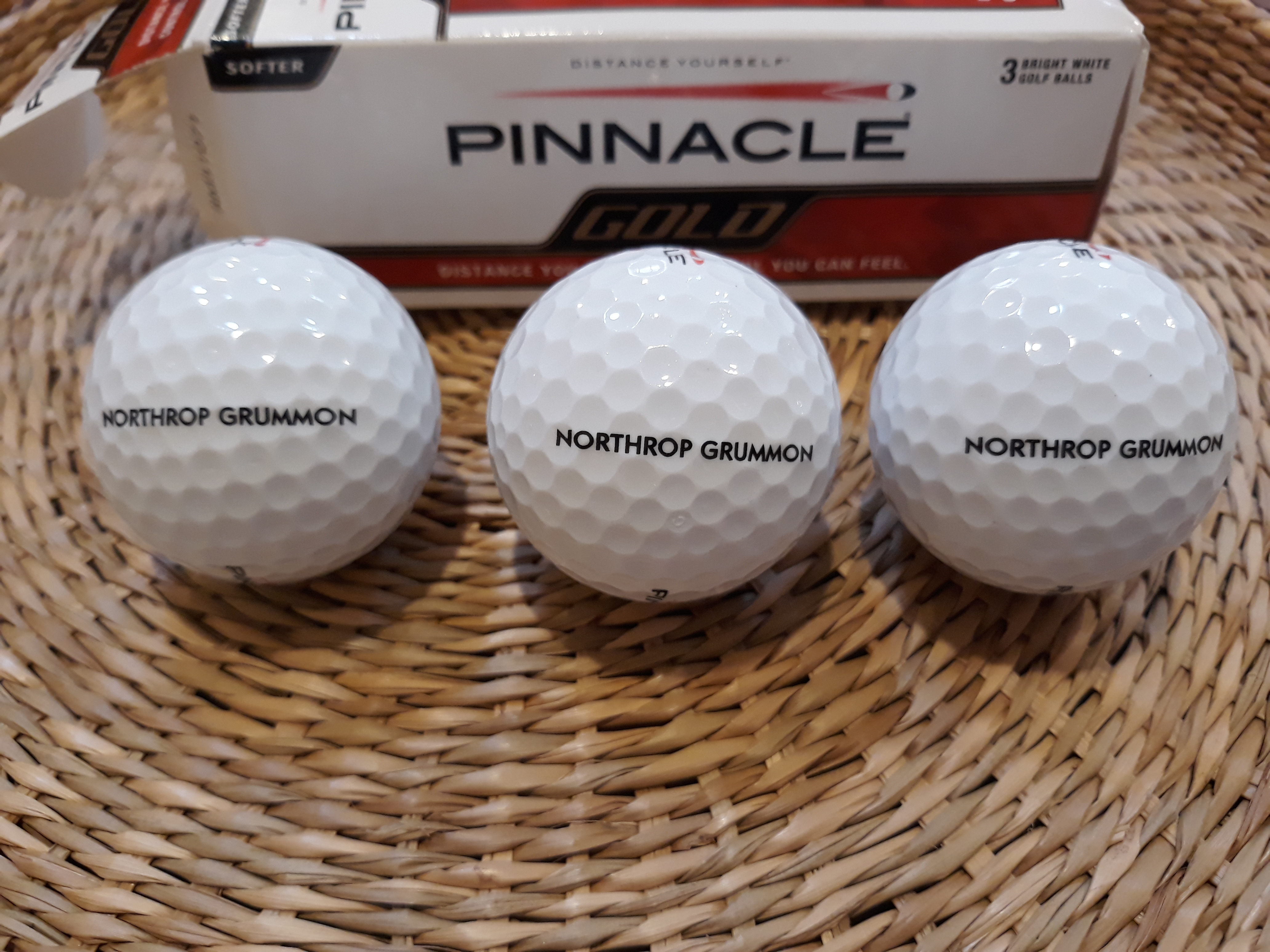 Golf balls with the name Northrop Grumman mis-spelled